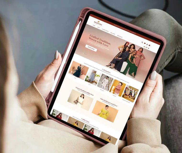 A woman browsing the Saubhari eCommerce fashion website on a tablet, showcasing elegant ethnic wear and modern collections — a Thinkster-designed online store emphasizing UX, responsiveness, and visual storytelling.