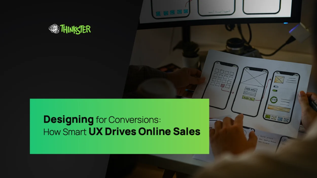 A UX designer sketching mobile app wireframes on paper while analyzing interface layouts on a monitor — symbolizing smart user experience design that enhances conversions, reflecting Thinkster’s expertise in UX and digital strategy.